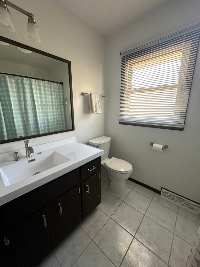 Full bathroom with laundry chute, shower over tub. - 3202 W Alvina Ave