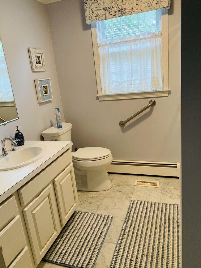 The bathroom features marble radiant heated floors and a large walk in shower - 8 Myrica Ave