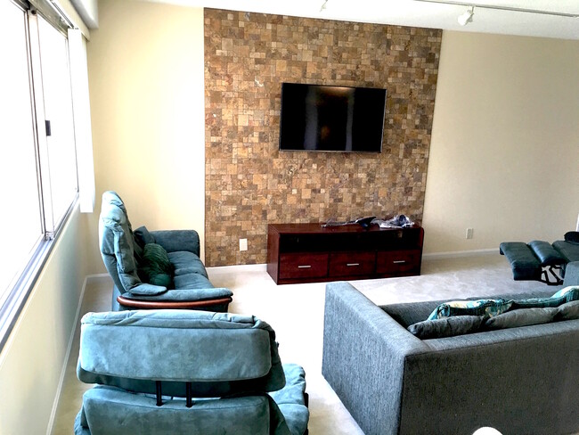 Living room TV on Stone Wall - 5500 Friendship Blvd