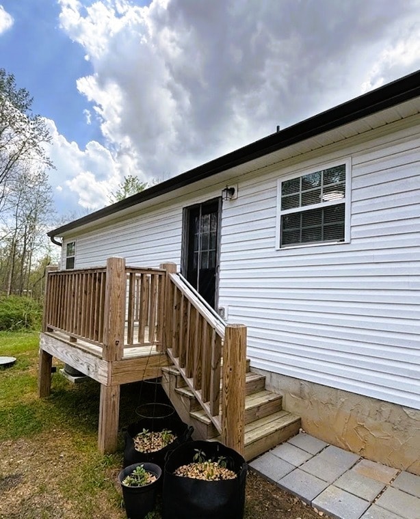 Rear deck with exterior steps for easy backyard access - 111 Buster Ln