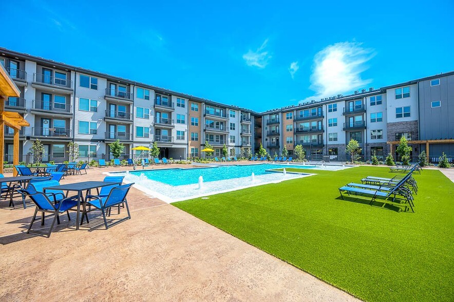 view of swimming pool featuring a lawn and pool water feature - Avasa Spring Branch