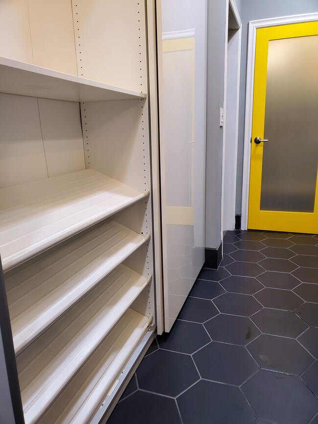 Bathroom closet with shoe rack in bathroom - 579 W. 13th St