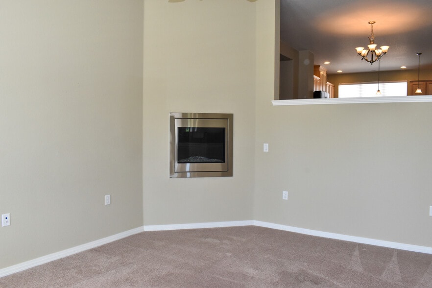 Family Room gas log fireplace with half wall open to dining room and kitchen - 684 Mason St