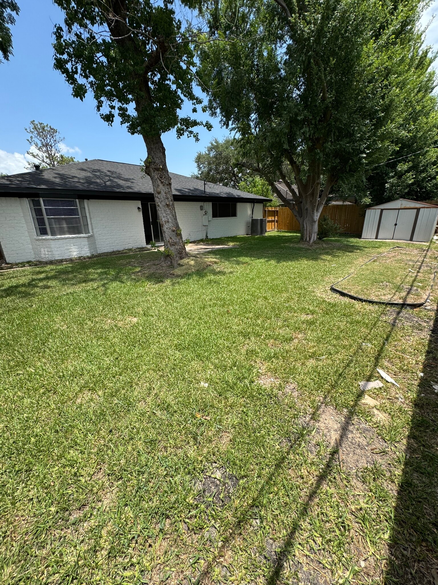 Spacious backyard with mature trees and plenty of room to relax or entertain. - 11927 Troulon Dr