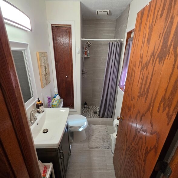 primary 3/4 bathroom. newer ceramic flooring and shower surround - 2248 139th Ave NW