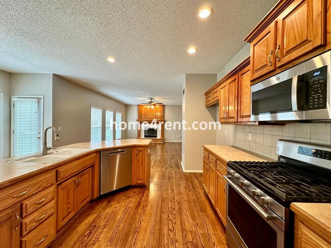 Building Photo - Beautiful Four-Bedroom Home with Three Car Garage, Wood Floors, Finished Basement and a Fenced Ya...