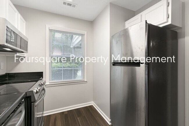 Building Photo - Charming 1st-Floor End-Unit Condo with Gas Log Fireplace, Private Back Porch & Community Pool – T...