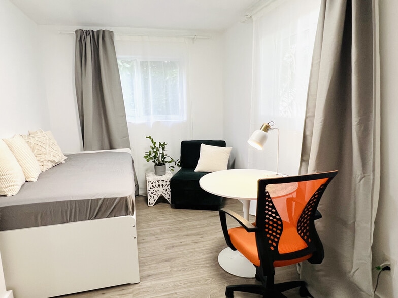 2nd bedroom with twin bed and desk. Garden views - 6863 NW 2nd Ave