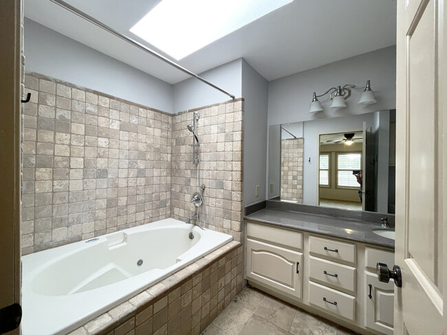 Primary bathroom brings in a ton of natural light through the skylight - 2914 Broadmoor Dr