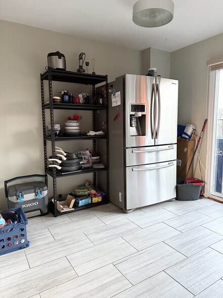 Another view of the kitchen in its current state showing the stainless fridge and misc. - 4767 Kandel Ct