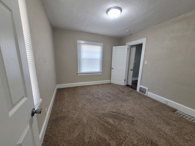 Building Photo - Two bedroom, One Bathroom Home with Partially fenced back yard