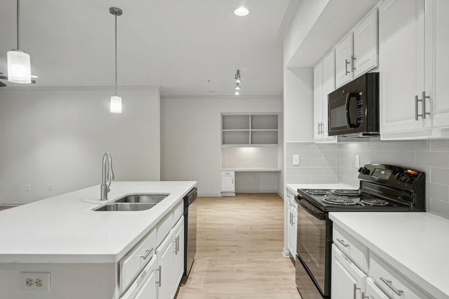 Large kitchen island and timeless backsplash - The Henry at Jones Road