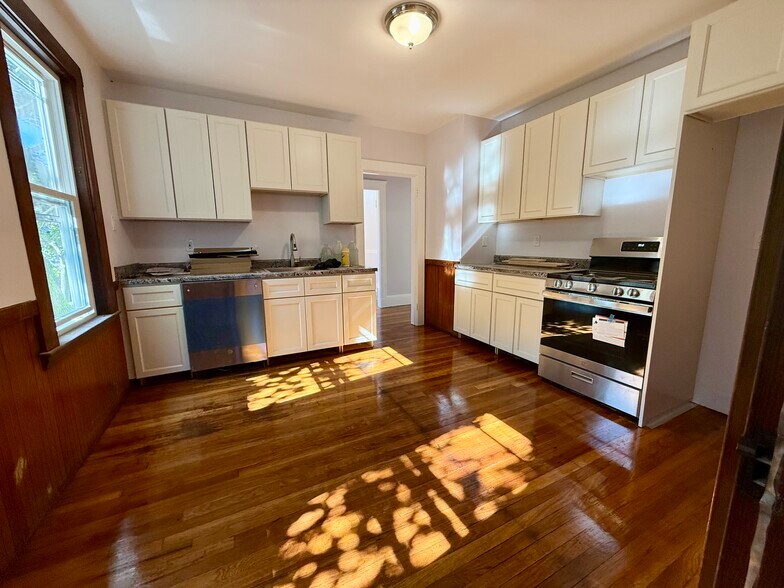 Nice sized kitchen with tons of cabinet space and two counters. Ample space for table or island. - 27 Seven Pines Ave
