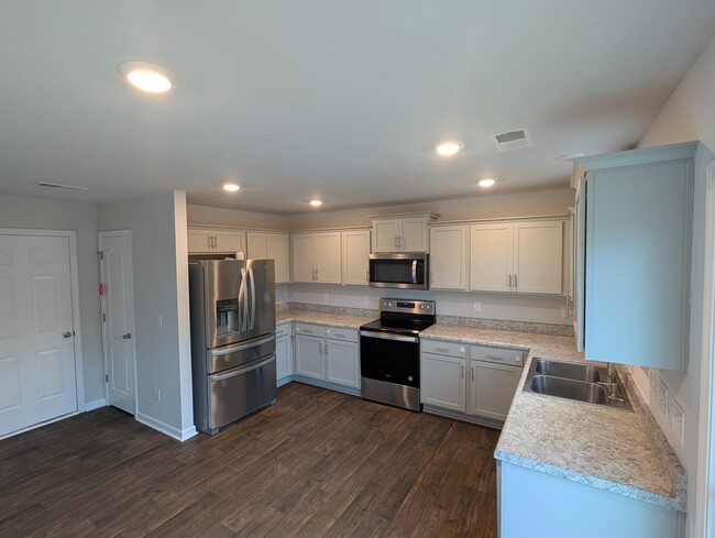 Kitchen with access to the garage. - 1682 Weatherend Dr