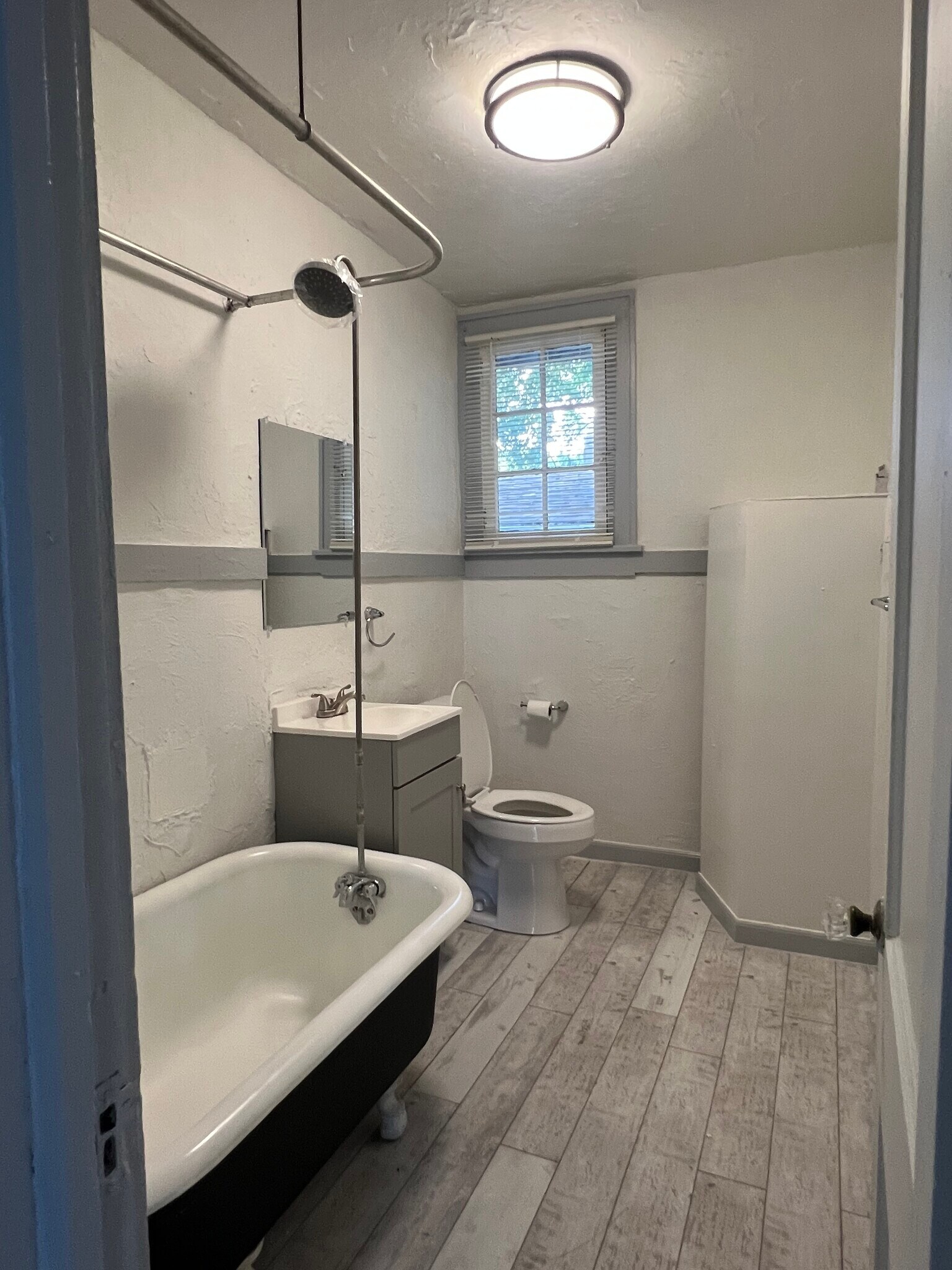 Bathroom with new flooring, paint, vanity and toilet - 669 Avenue B NW