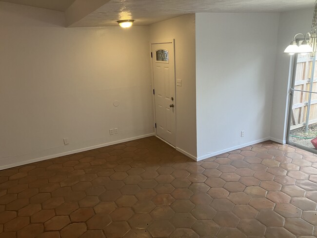 View from the hallway/living room to the front door/dining room. - 13559 Red Fern Ln