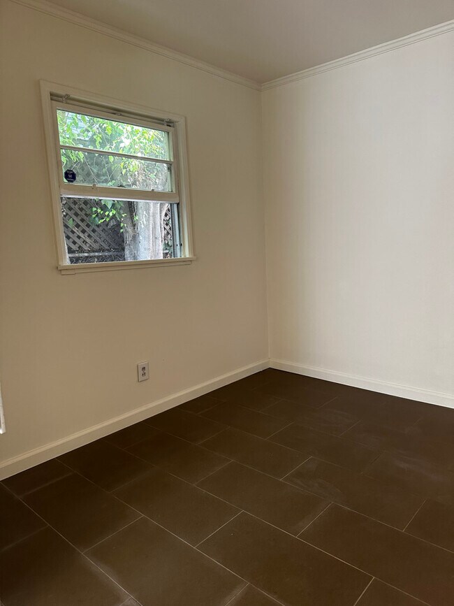 Bedroom with tiled floors throughout the home. - 924 Nowita Pl