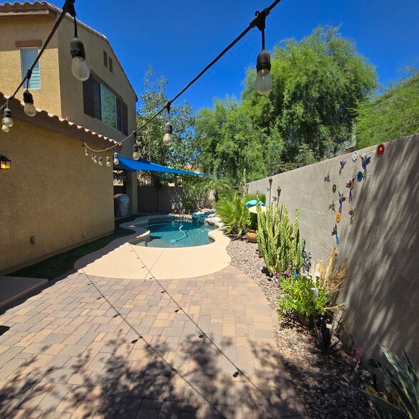 Extended backyard patio next to garage access door - 280 E Indigo Dr