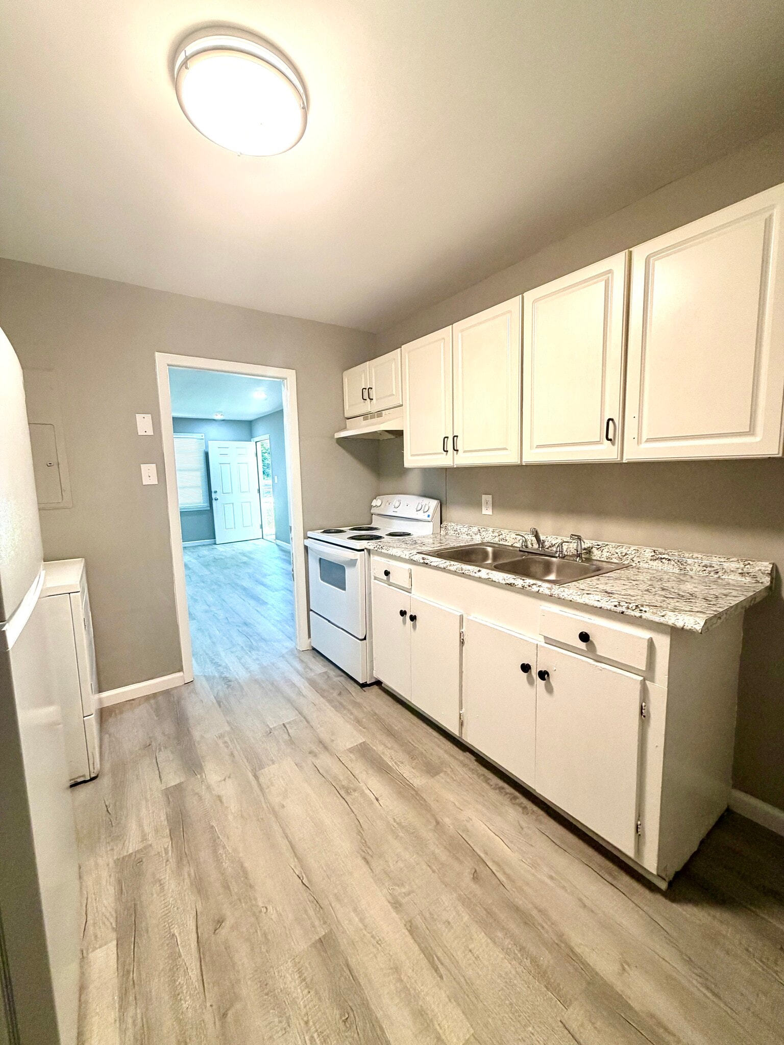 Kitchen View - Ample cabinet storage, granite-style countertops, and an open layout. - 125 Trio Ln