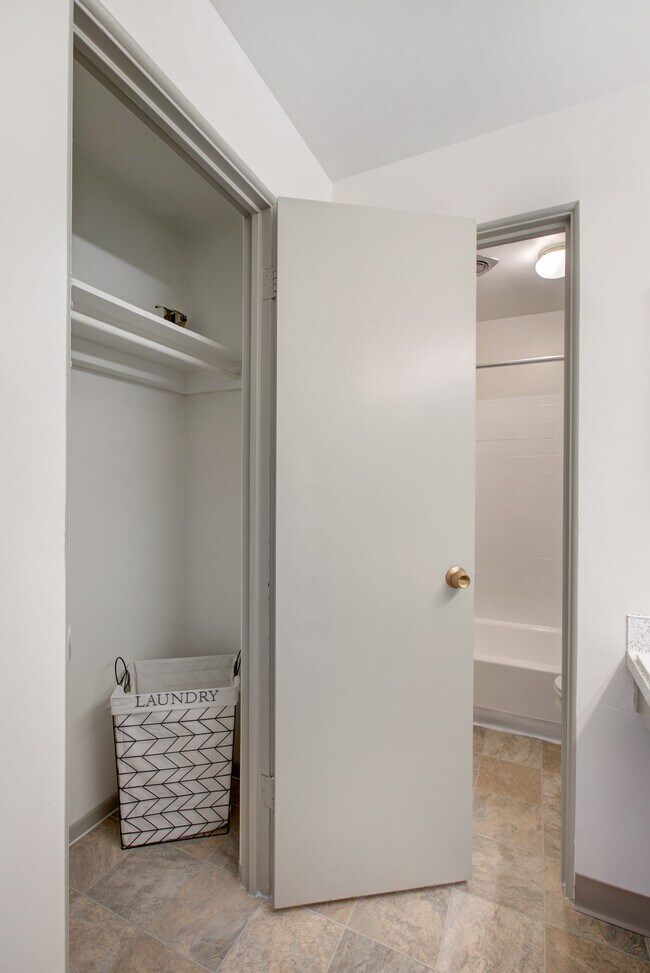 Maximize your apartment's efficiency with this modern storage and laundry solution. - Harmony Apartments