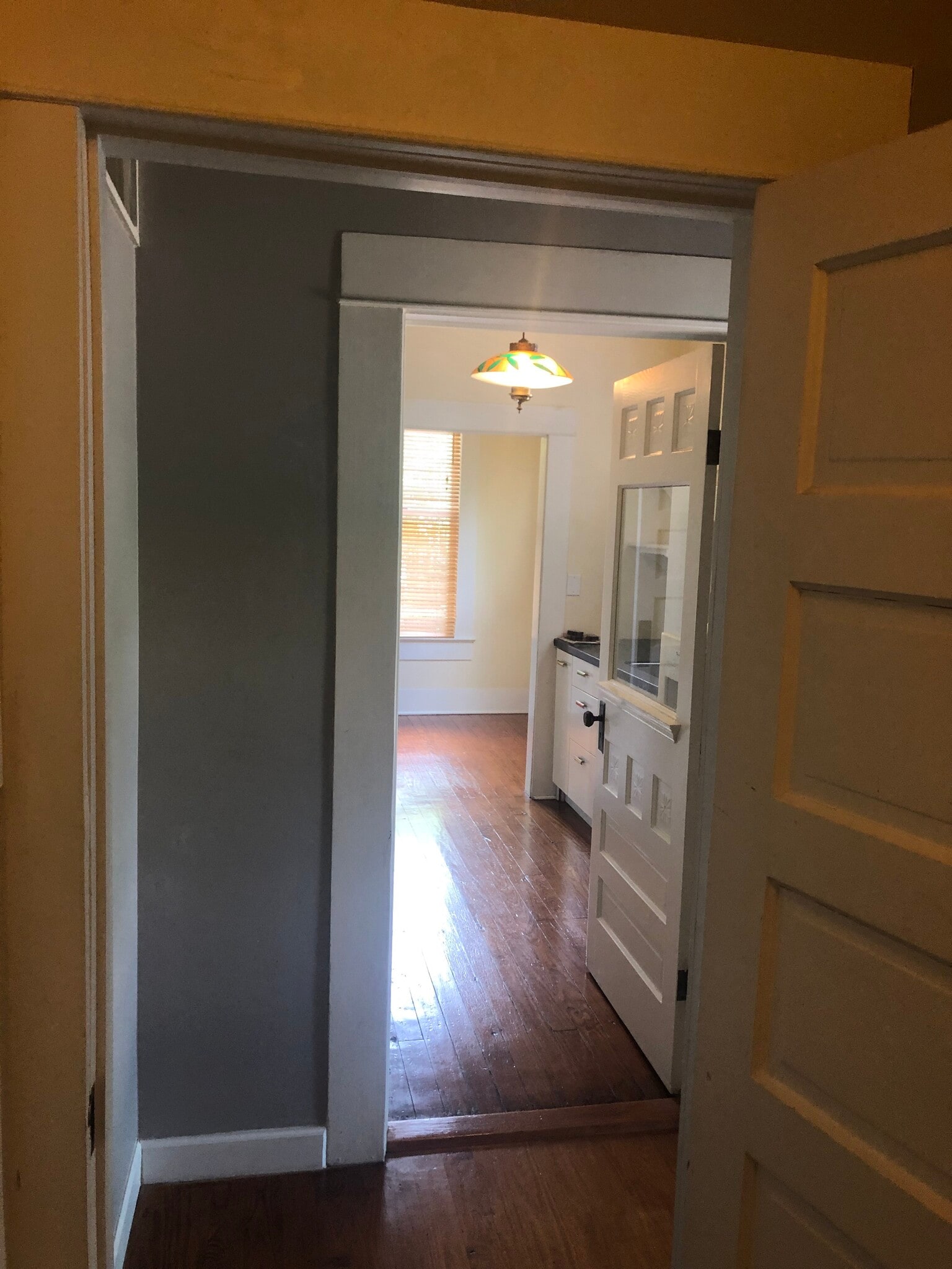 View thru entry hall near bathroom and small bedroom into the kitchen - 704 E Guenther St