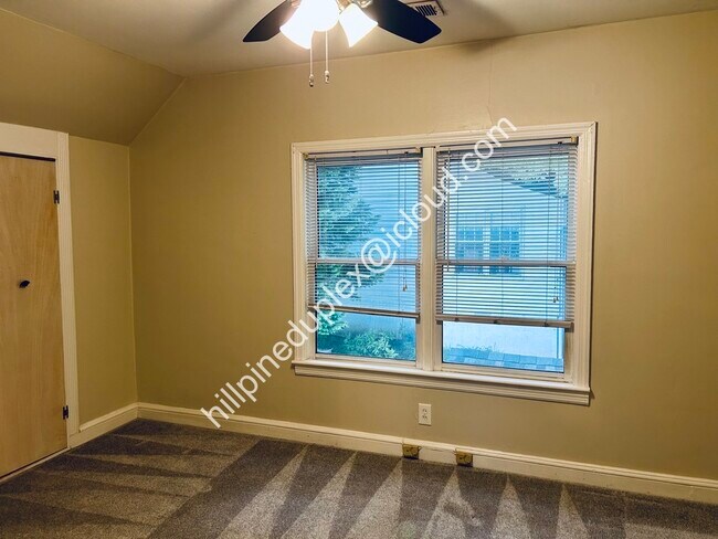 Second bedroom with large closet. Great bedroom or home office. - 629 Hillpine Dr NE