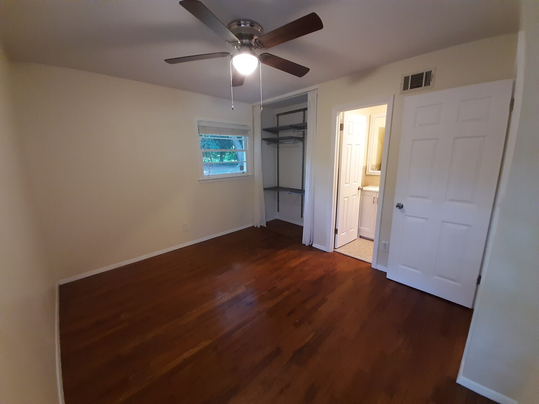 This bedroom has a large closet with adjustable shelving and a private half bathroom. - 2955 Fantasy Ln