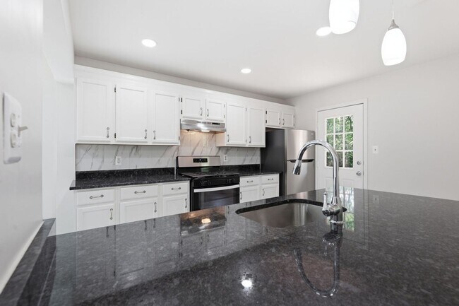 Building Photo - Experience contemporary living in this beautifully renovated residence where modern design meets ...