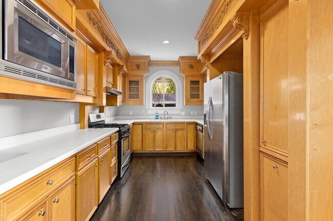 White limestone countertops, natural wood cabinets - 515 W 17th St