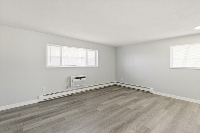 Experience comfort in this bright and open living room with sleek design. - Country Club