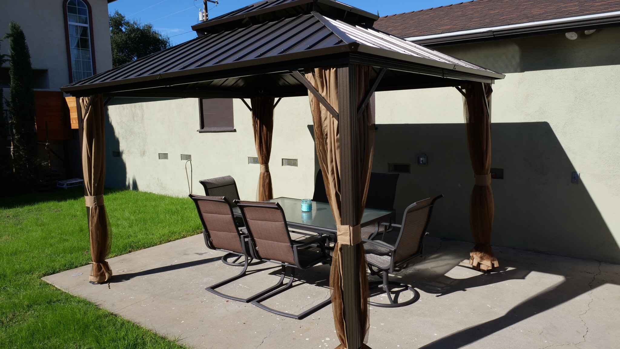 Gazebo includes privacy shades, six person table and chair setting. - 259 E Puente St