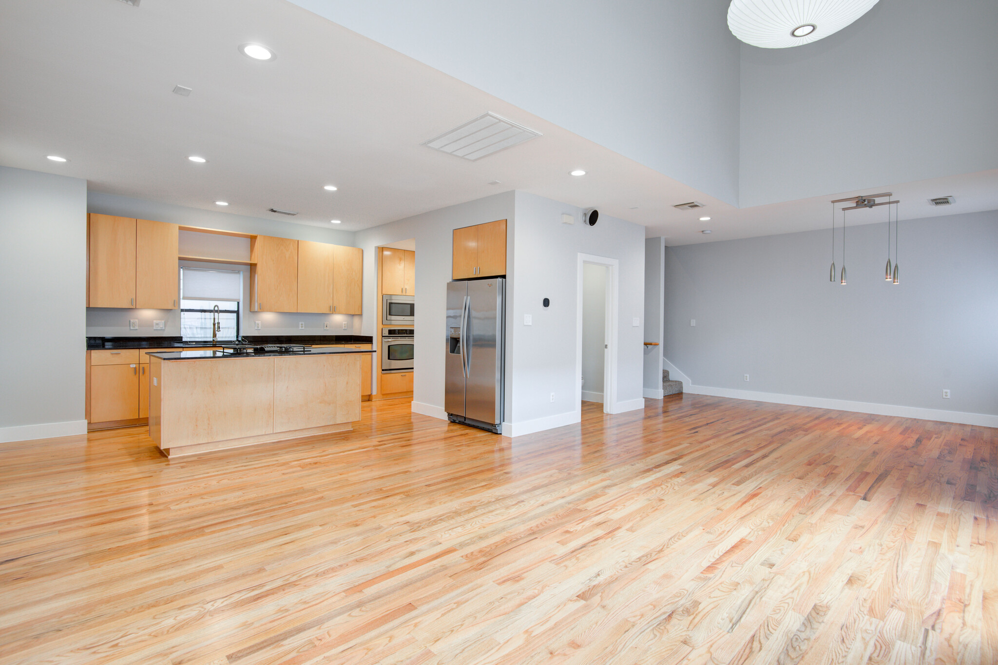 Another view of main floor with kitchen pictured. - 4202 Spencer St