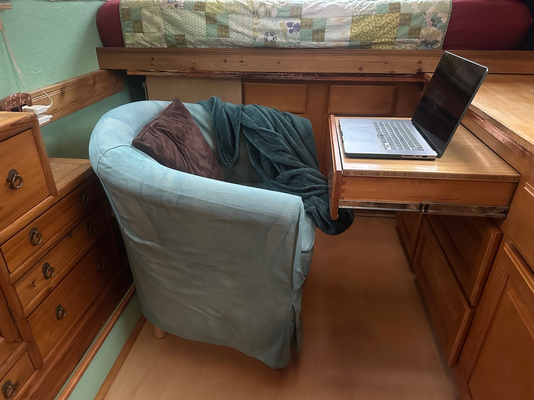The comfy chair can be pulled around and the tabletop added to the drawer to create a little workspa - 833 Valencia St