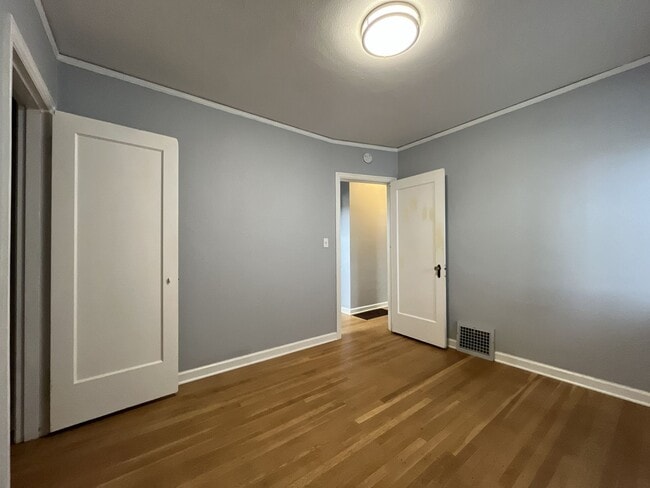 Building Photo - Three-Bedroom Home with Updated Kitchen & Vaulted Ceilings, large open basement, Hardwood floors