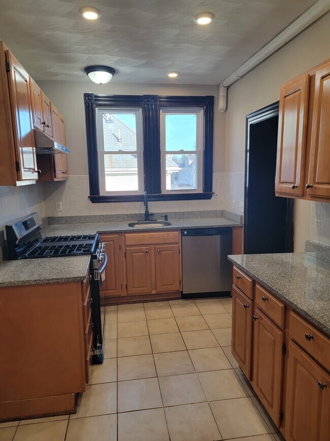 Kitchen with modern counter top including new appliances such as dishwasher and new stove top - 15 Locust St