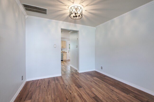 Building Photo - Modern Elegance: 3-Bedroom Townhome with Wood Flooring, Shaded Deck, and Inclusive Amenities
