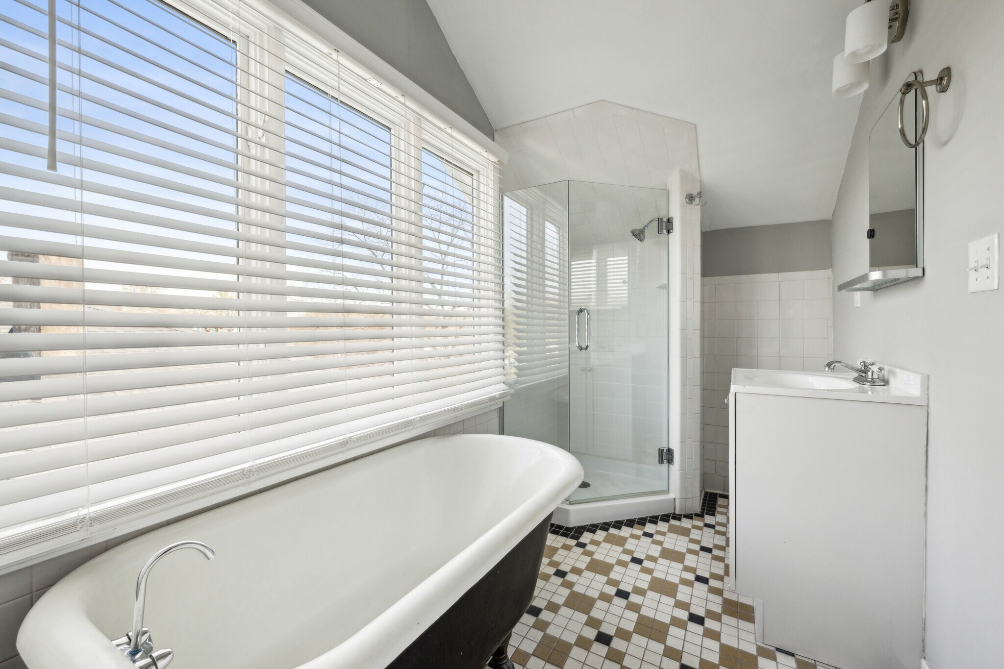 Full bathroom located on the third floor includes a walk in shower and soaking tub with views - 1118 Colquitt Ave NE