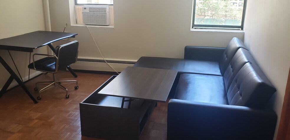 Living room with sofa bed, raised coffee table - 240 E 23rd St
