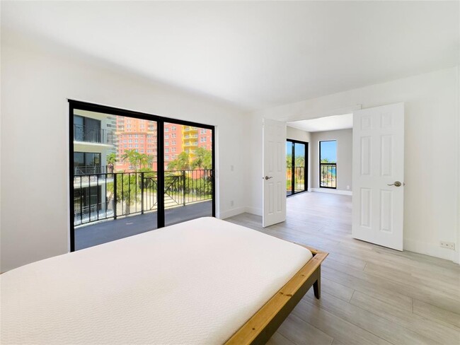 The primary suite looks onto the balcony, and when the French doors are opened, see ocean from bed - 2029 N Ocean Blvd