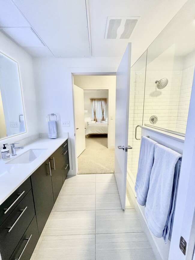 Luxury en suite includes a frameless glass shower, lovely mirrors framed with HD lighting. - 2530 Lawrence St