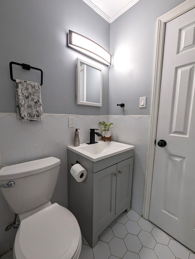 The bathroom is completely updated with custom tile work a rain shower and modern fixtures. - 4107 Crane St