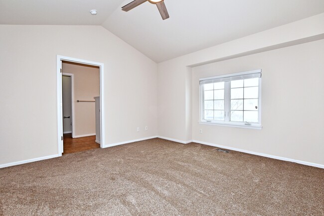 Primary suite with vaulted ceilings and ensuite bathroom - 6349 Orchard Park Dr