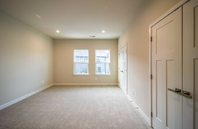 Building Photo - This 3-bedroom, 3-full bathroom townhouse offers a pristine and contemporary living experience.