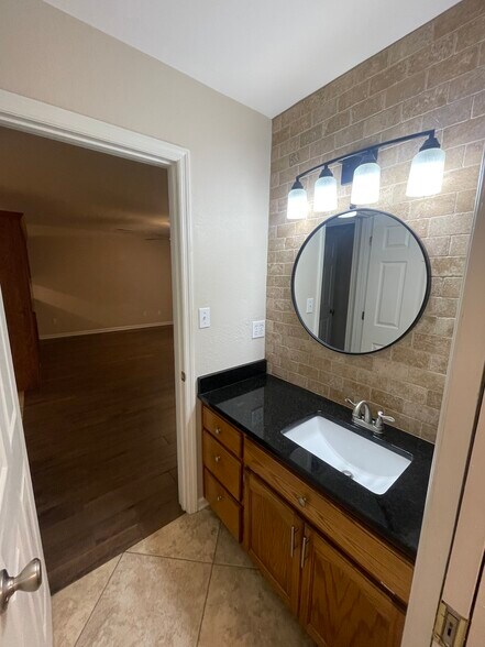 Bathroom has tiled vanity wall and granite countertops - 5191 County Road 73