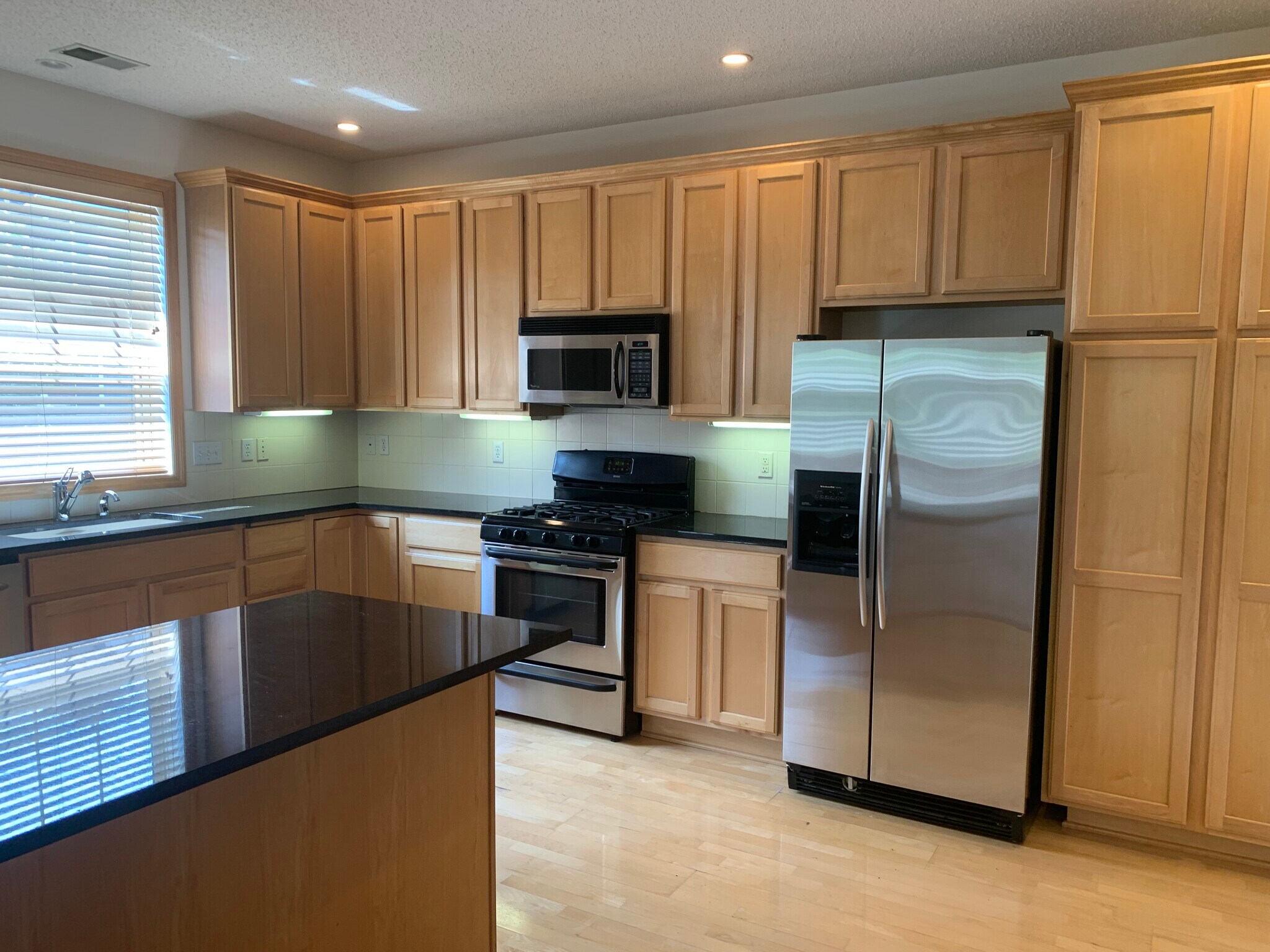 Granite countertops and eat in island. Maple cupboards and flooring. - 1530 Zarthan Avenue South