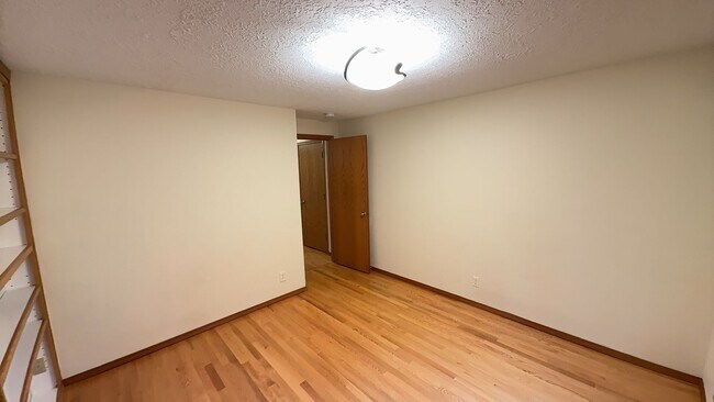 Building Photo - 4bd/3ba HUGE Home w/Hardwood Floors, Russian Fireplace, 2-Car Garage & Fenced Back Yard!