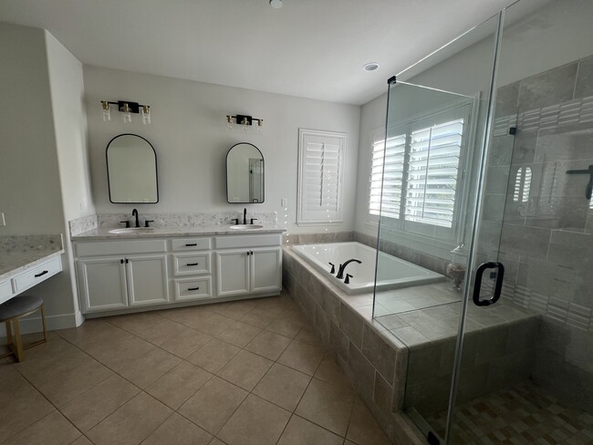 Primary bathroom with glass shower door and oversized bathtub - 34189 Hourglass St