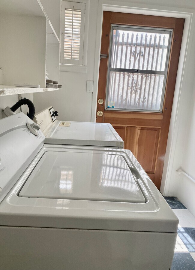 Laundry area with washer, dryer, and back door leading to the deck. - 1672 Rotary Dr