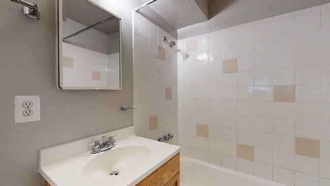 Experience comfort in this well-designed bathroom space, perfect for daily routines. - Harmony Apartments