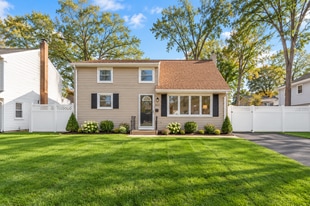 Inviting curb appeal with a well-maintained front lawn, attractive landscaping, and a welcoming entr - 237 Johnson Ave
